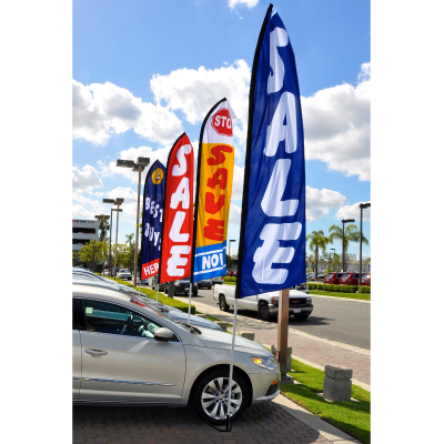 Sale swooper flags displayed along an automotive dealership lot
